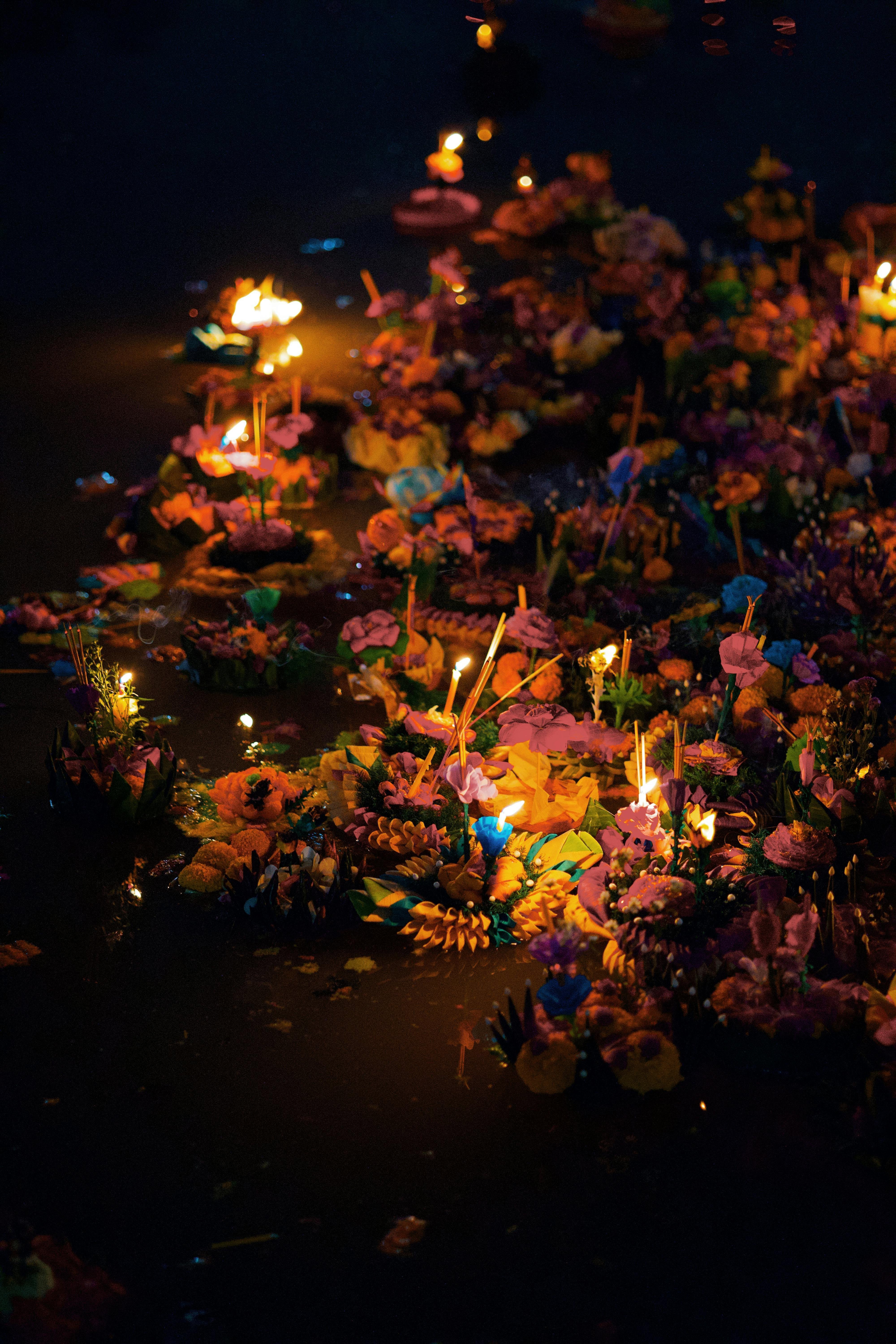 Krathong candles floating on water at the closing ceremony